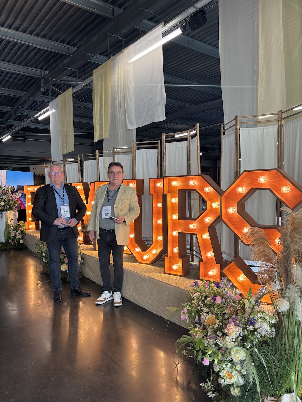 Bordeaux 2025 Primeurs tasting event with illuminated PRIMEURS letters and floral arrangements
