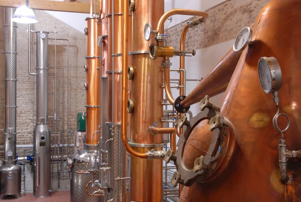 Copper stills and stainless steel distillation columns inside the Bottega distillery