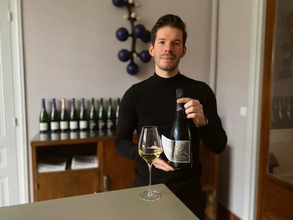 Thomas Lombard presents a bottle and the vineyard sites