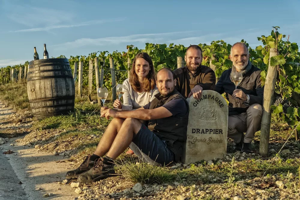 Michel Drappier tending his vines with his three children